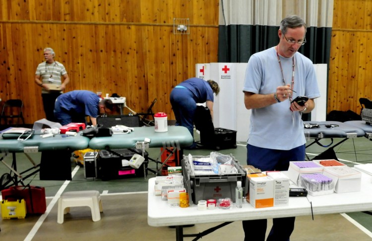 Alan Pratt, supervisor for the American Red Cross team that operated a blood drive in Belgrade on Thursday, with other staff closes the event held at the Community Center for All Seasons. Another driver, part of the Red Cross 9/11 rememberance, will be held at the Augusta Civic Center Friday.