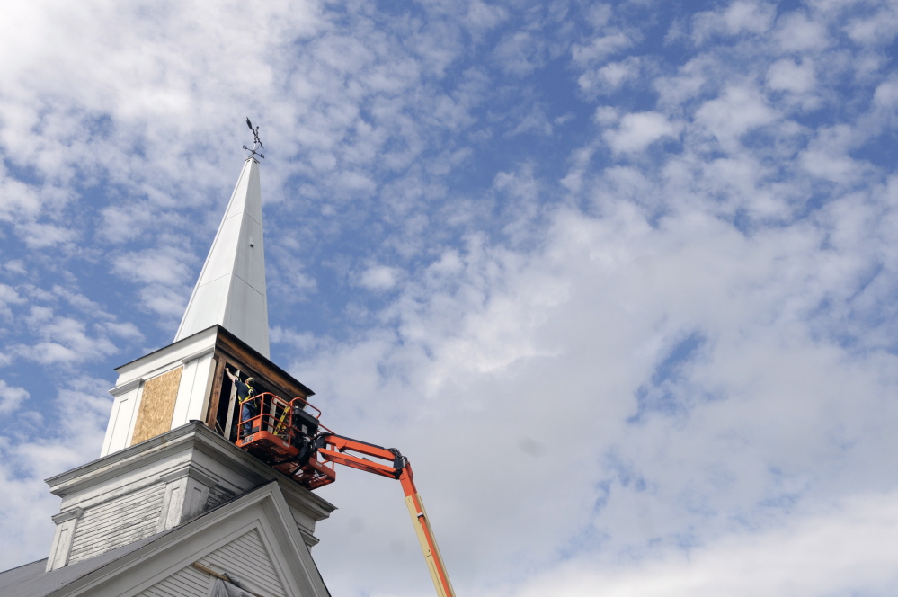 Workers frame the steeple at the North Monmouth Community Church earlier this week.