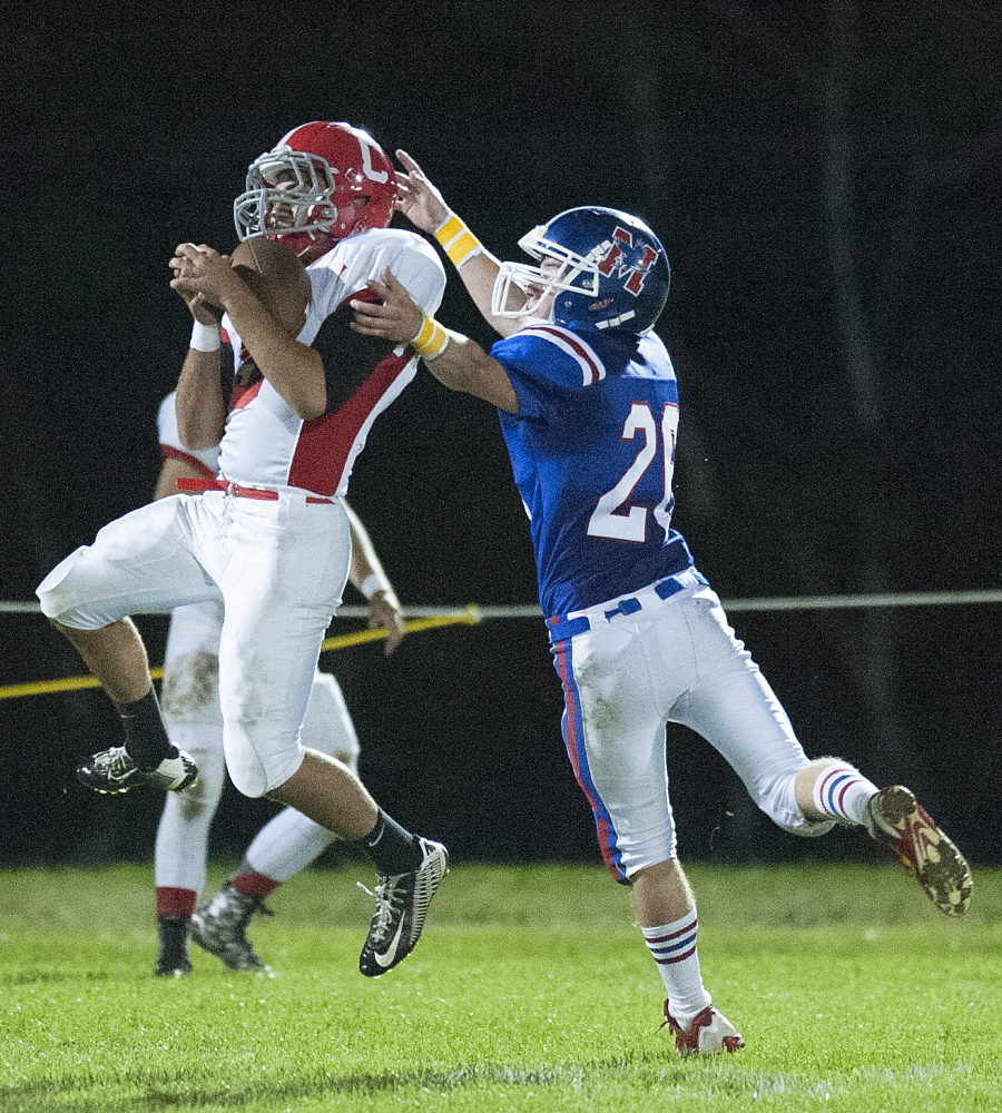 Kevin Bennett photo 
 Cony receivers Joey Younes, left, catches a pass under pressure from Messalonskee's CJ Gordon during the second quarter of a Pine Tree Conference Class B game Friday night at Veterans Field in Oakland.