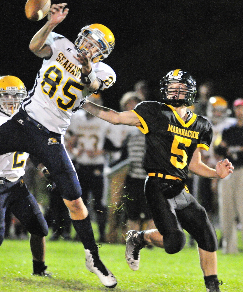 Boothbay’s Abel Bryer, left, knocks away a pass intended for Maranacook’s Brandyn Michaud on Friday night at Ricky Gibson Field of Dreams in Readfield.