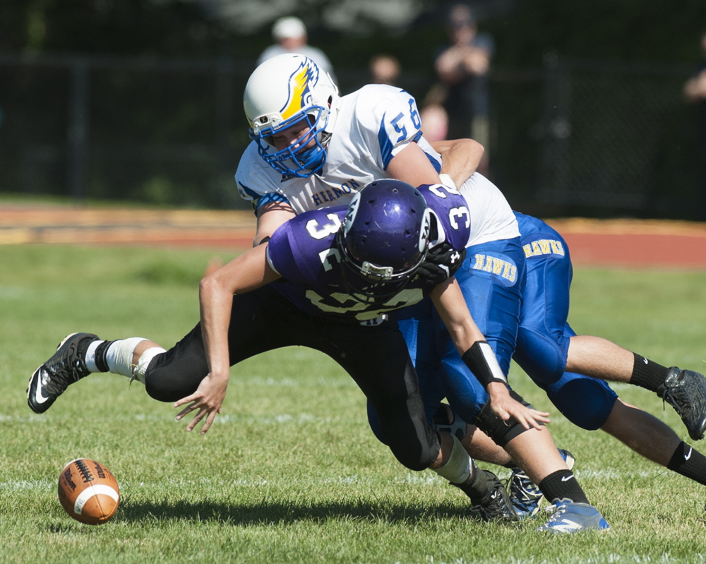 Kevin Bennett photo 
 Hermon's Garrett Mullen knocks the ball free as he brings down Waterville's Gavin LaChance during the second quarter Saturday in Waterville.