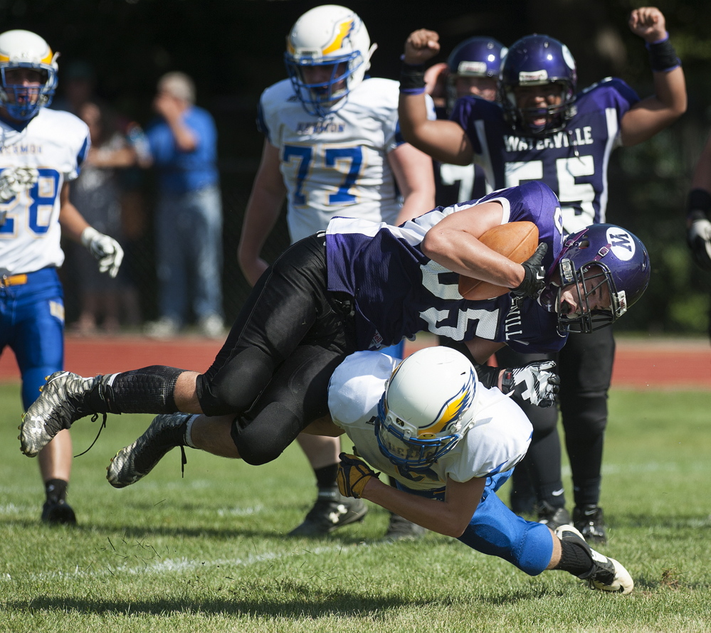 Kevin Bennett photo 
 Waterville's Devon Begin scores a dives into the end zone as he is taken down by Hermon's Tyler Carmichael during the second quarter Saturday at Waterville.