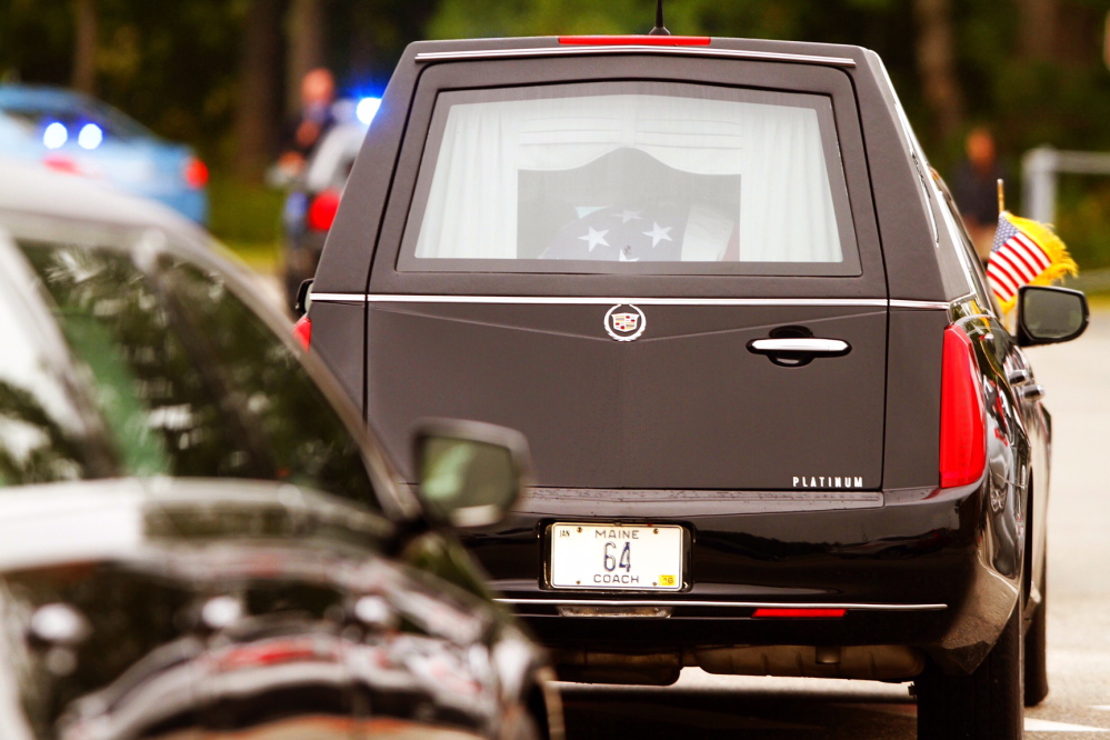 The hearse carrying Leon Gorman’s flag-draped casket from the Westbrook Performing Arts Center after his memorial service Sunday.