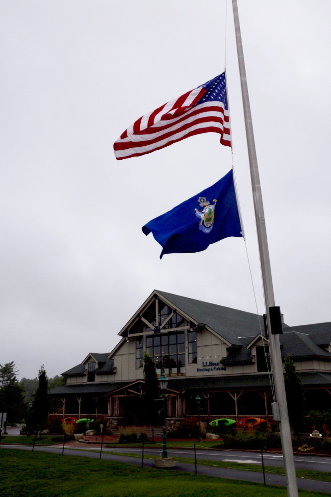 Flags fly at half-staff Sunday at the L.L. Bean flagship store in Freeport.