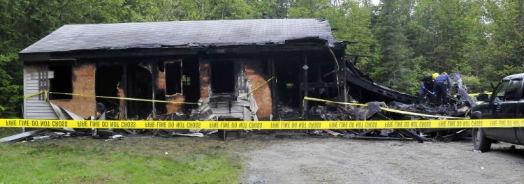 State fire marshal investigators Jeremy Damren and John Wardwell look for clues as to what started the fire that destroyed a home at 72 Maple Lane in Canaan early Sunday. Damren said the cause is undetermined.