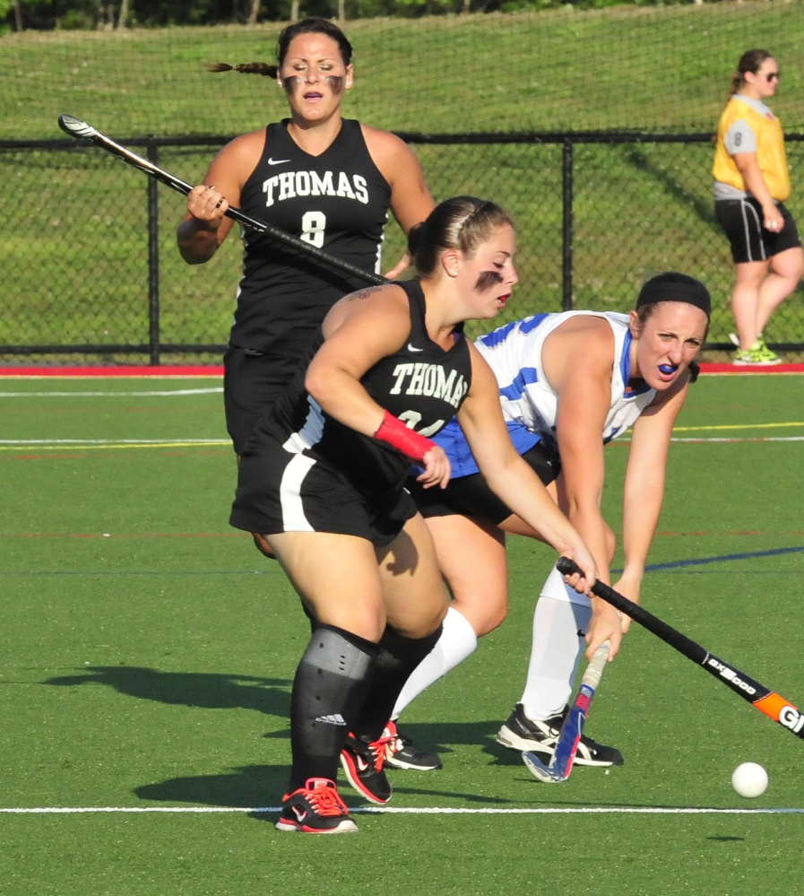 Thomas’  Lindsay Morong battles for possession as teammate Emily Leighton backs up during a recent game against Colby in Waterville.