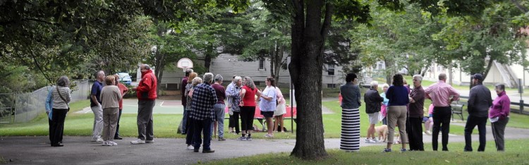 Visitors congregate during a rededication of Cunningham Park in Augusta on Sunday.
