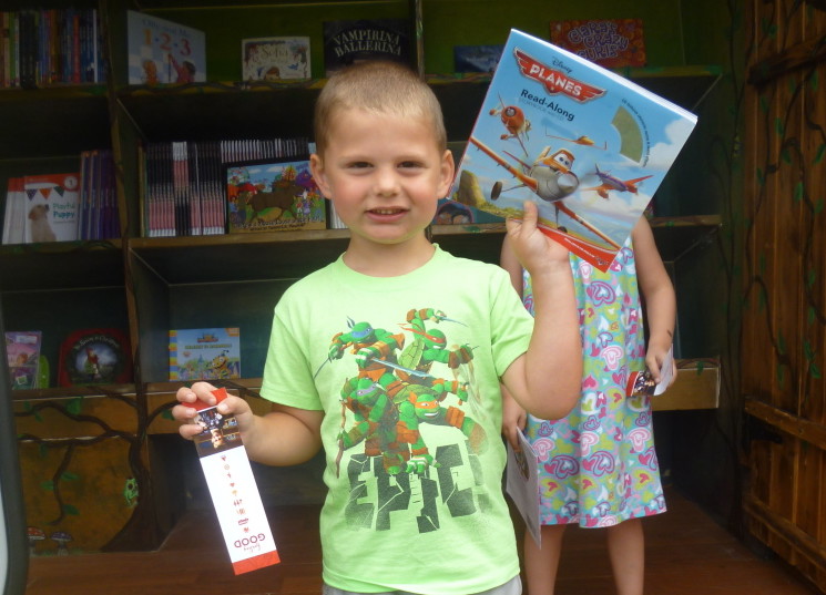 Caleb O’Rourke, an Educare Central Maine preschooler, shows off his new book about planes.