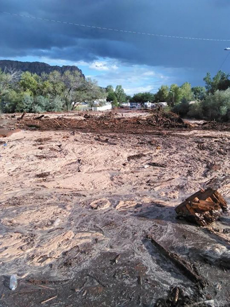 Debris and water cover the ground after a flash flood Monday in Hildale, Utah. Authorities say multiple people are dead and others missing after a flash flood ripped through the town on the Utah-Arizona border Monday night.