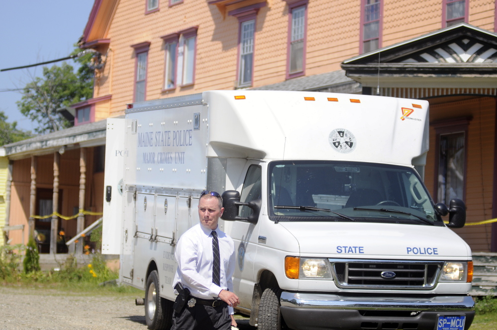 A Maine State Police detective walks out of the driveway of a East Pittston boarding home on Aug.16, 2015, following the fatal stabbing there the previous day of 51-year-old Dale Clifford.