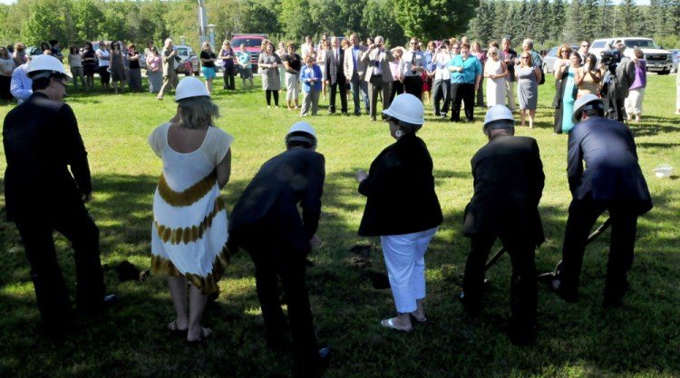 A large crowd of supporters watch as officials take part in a groundbreaking ceremony for the Woodfords Family Services building on Chase Avenue in Waterville. The center will be on the same site as the former Seton Hospital, which developer Kevin Mattson said Tuesday he plans to turn into apartments.