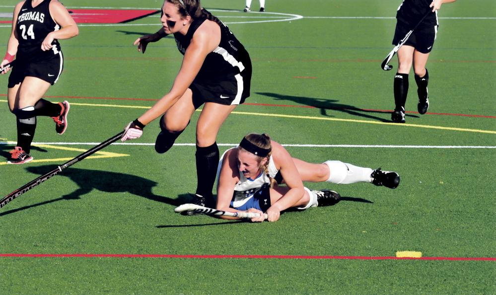 Thomas and Colby College field hockey players play on artificial turf during a recent game.