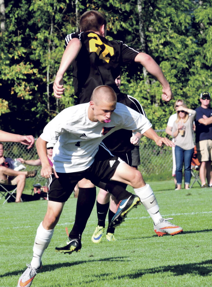 Staff photo by David Leaming 
 Winslow's Noah Dugal, front, and Maranacook's Mark Buzzell collide during a game Thursday in Winslow. Maranacook won 2-1.