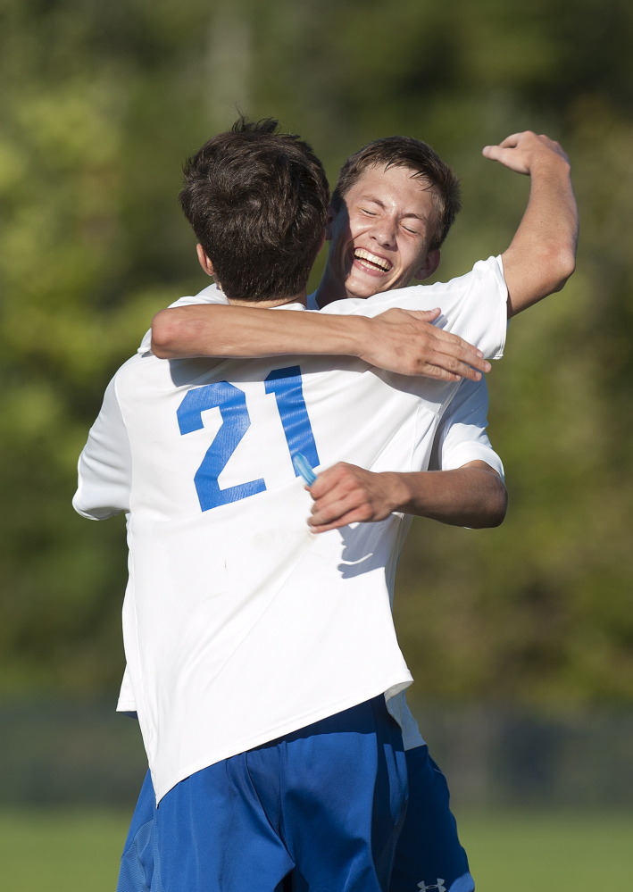 Kevin Bennett photo 
 Messalonskee's James Koulertsis, right, celebrates Ryan McCarthy's goal in the second half that gave the Eagles a 3-1 lead over Cony during a Kennebec Valley Athletic Conference Class A game Friday afternoon.