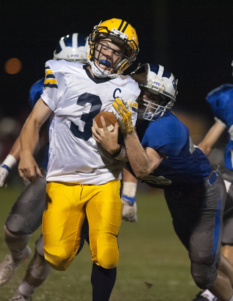 Mt. Blue’s Ryan Pratt is shoved out of bounds by Lawrence’s Curtis Martin during the second quarter Friday in Fairfield.