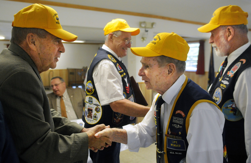 AUGUSTA, ME - SEPTEMBER 20: John Morris, left, is congratulated Sunday September 20, 2015 by Bucky Walters as Willis Clifford, right, congratulates Paul Talbot for their nomination to the The Holland Club, for submariners who survived 50 years after going to sea on a submersible boat, during a ceremony in Augusta.  Morris, Maine's Public Safety Commissioner and a resident of West Gardiner, served on the USS Tunny in 1965.  Talbot, a resident of Corinna, first qualified aboard the USS Clamagore in 1964.  Gov. Paul LePage, second from left, attended the event. (Staff photo by Andy Molloy/Staff Photographer)