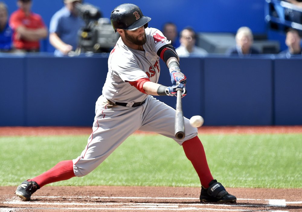 Boston Red Sox second baseman Dustin Pedroia hits a single against the Toronto Blue Jays during the first inning Sunday in Toronto.