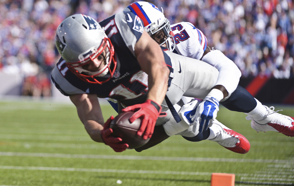 New England Patriots wide receiver Julian Edelman (11) dives past Buffalo Bills free safety Aaron Williams (23) for a touchdown during the second half Sunday in Orchard Park, N.Y. The Patriots won 40-32.