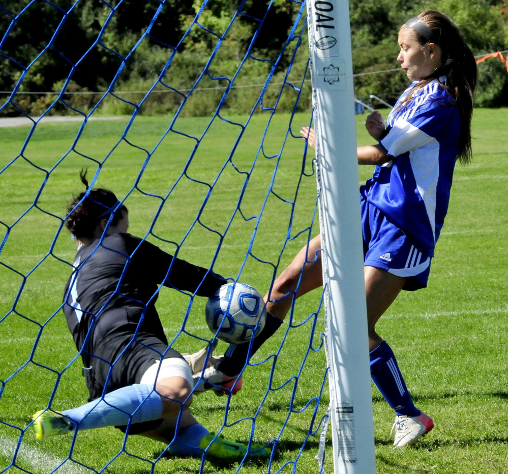 Colby’s Hannah Brozdowski gets the ball past Connecticut College goalie Bryanna Montalvo during a game Sunday in Waterville.