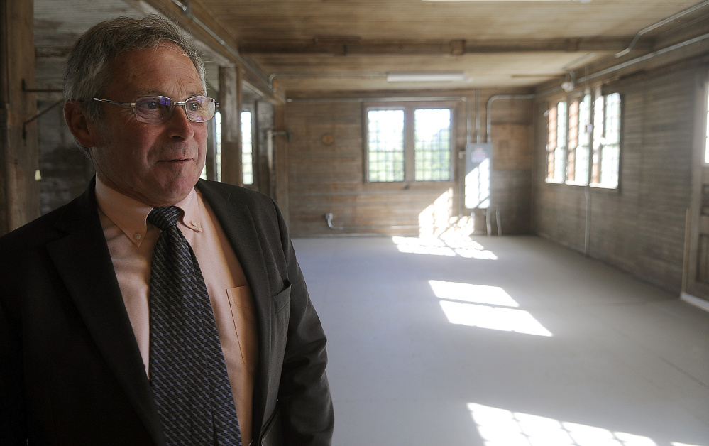 Walter E. Whitcomb, commissioner of the Maine Department of Agriculture, Conservation and Forestry, inspects the interior of the Campbell Barn in Augusta Monday during a dedication ceremony for the renovated structure at the state complex on the city’s east side.