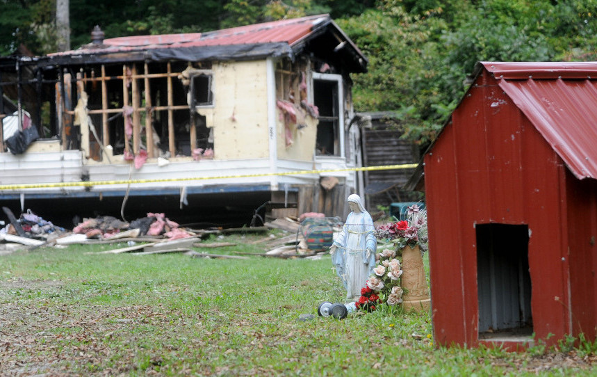 A mobile home at 289 Brown’s Corner Road in Canaan was destroyed in fire on Monday and according to neighbors pets were killed by the blaze. This photo shows the charred remains of the home juxtaposed to the dog house and a statue of Mother Mary on Tuesday, Sept. 22, 2015. It is the third fire in that town in three weeks.