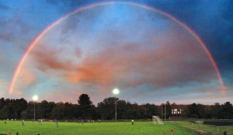 A rainbow glows of the Maranacook and Erskine boys teams during a soccer game Tuesday at The Ricky Gibson Field of Dreams in Readfield.