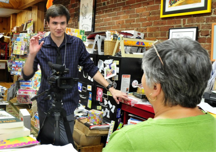 Mid-Maine Technical Center student Brad Calvin films Children’s Book Cellar owner Ellen Richmond at the Waterville store on Wednesday as part of a project recording people, places and things in downtown Waterville.