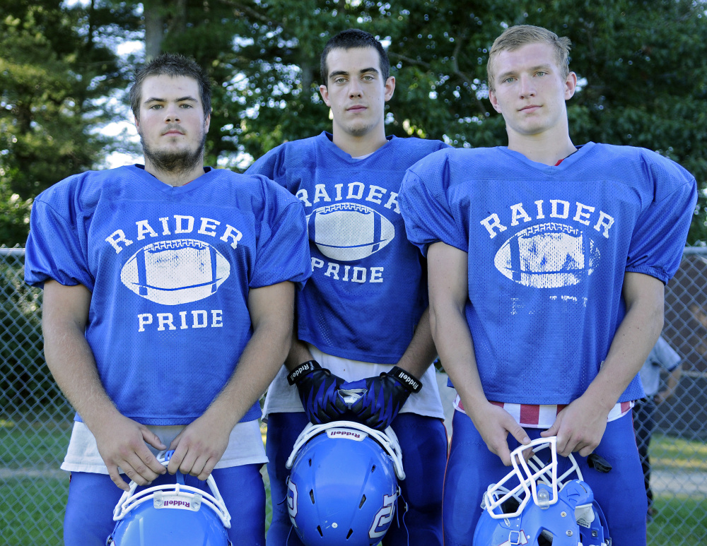 Oak Hill football players Garrett Gile, left, Austin Gaucher and Brendan Tervo give the Raiders depth on its offensive line, an advantage usually missing with Class D teams.