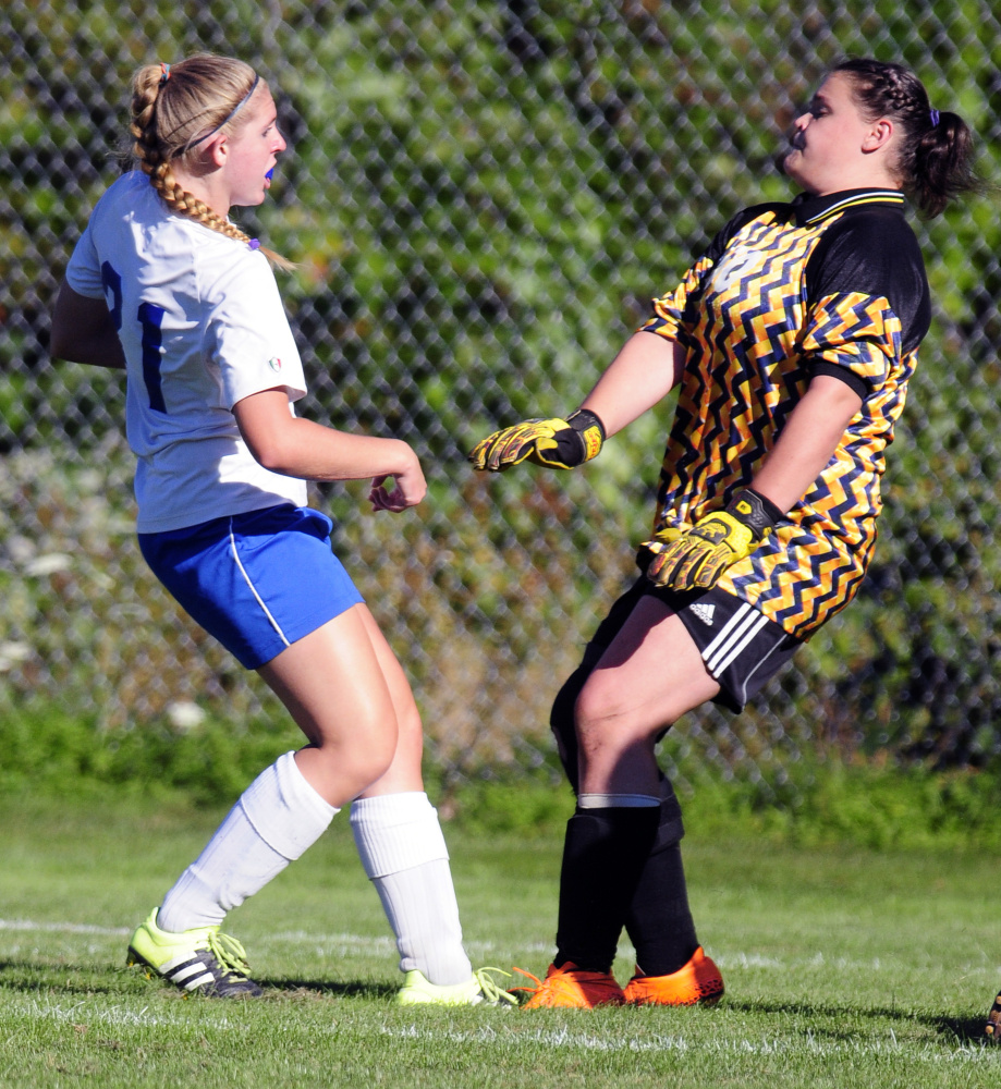 Oak Hill’s Brittany Marquis (21), left, watches ball go into net behind Hall-Dale keeper Hailey Taker to make score 1-0 during a game Wednesday in Wales.