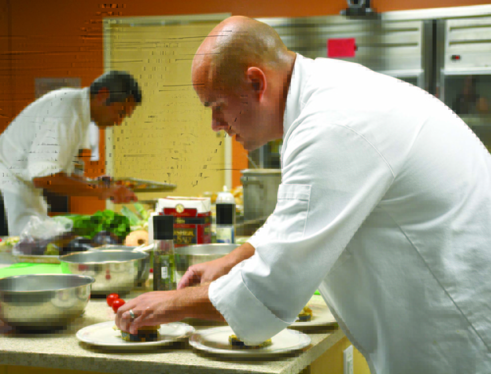 Blaine House executive chef Chris Hart, left, and MaineGeneral Food and Nutrition Services director Conrad Olin, right, plate their dishes before the judging at the Healthy Food Cook-Off.