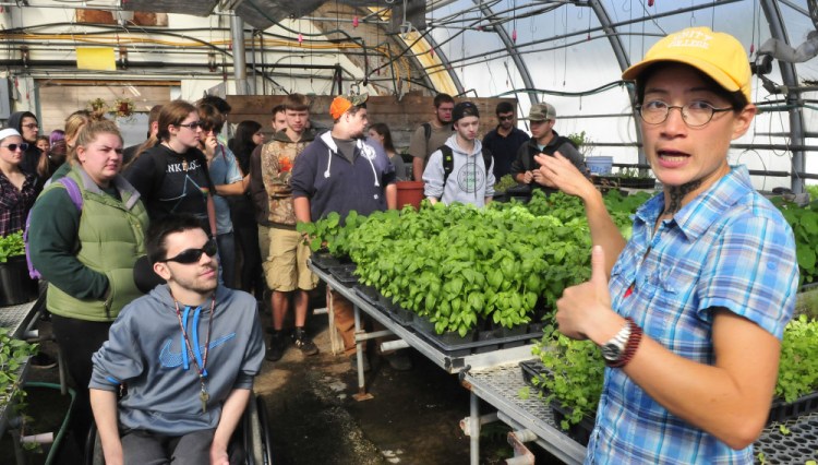 Unity College professor Mary Bulan leads new students on a tour of one of the greenhouses at the school McKay Farm Research Station in Thorndike on Thursday.
