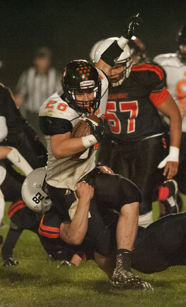 Kevin Bennett photo 
 Skowhegan's Garrett McSweeney, bottom, pulls Brewer's Dylan Severance down during a Pine Tree Conference Class B game Friday night in Skowhegan.