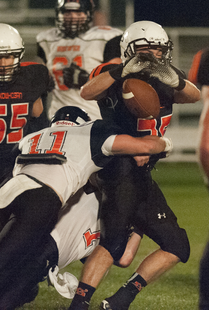 Kevin Bennett photo 
 Skowhegan's Spencer Salley has the ball stripped by Brewer's Danny Davis during the first quarter of a Pine Tree Conference Class B game Friday night in Skowhegan.