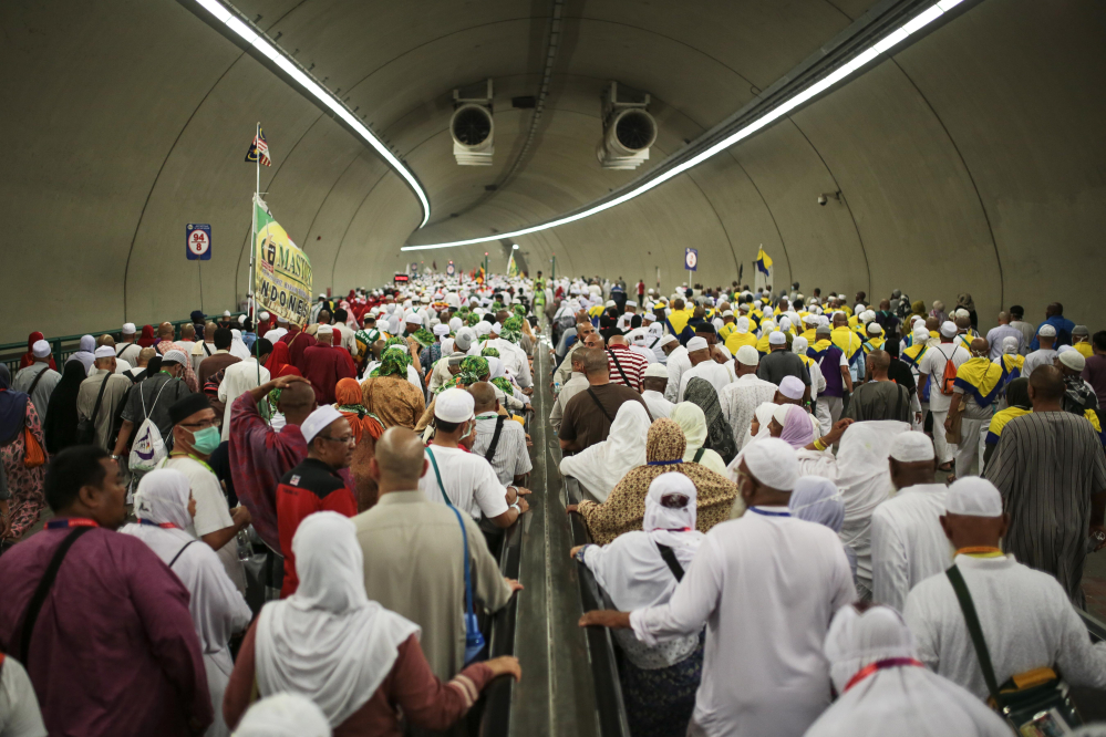 Muslim pilgrims walk in a tunnel on their way to cast stones at Jamarrat pillars, a ritual that symbolizes the stoning of Satan, during the annual pilgrimage, known as the hajj, in Mina, near the holy city of Mecca, Saudi Arabia on Friday.