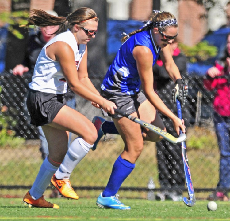 Staff photo by Joe Phelan 
 Gardiner's Skye Lavoie, left, tries to stop a run by Lawrence's Alexis Chamberlain during a Class B game Saturday at Thomas College.