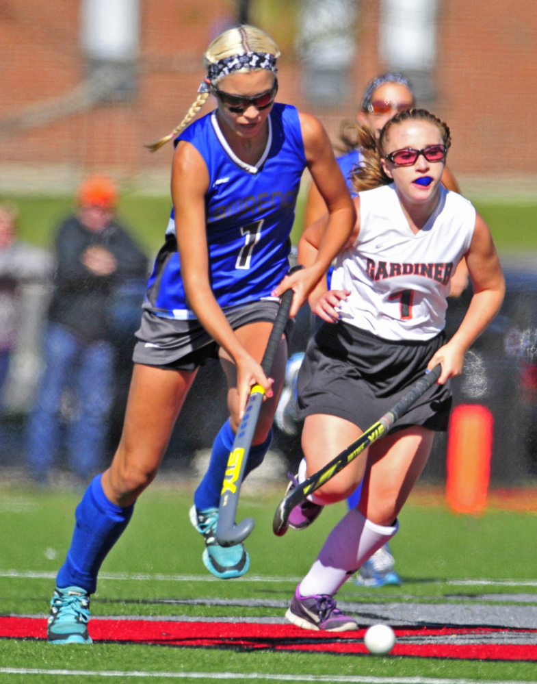 Staff photo by Joe Phelan 
 Lawrence's Hallee Parlin, left, tries to break away from Gardiner's Kalee Michaud during a Class B game Saturday at Thomas College's Bernatchez Field. Lawrence won 1-0.