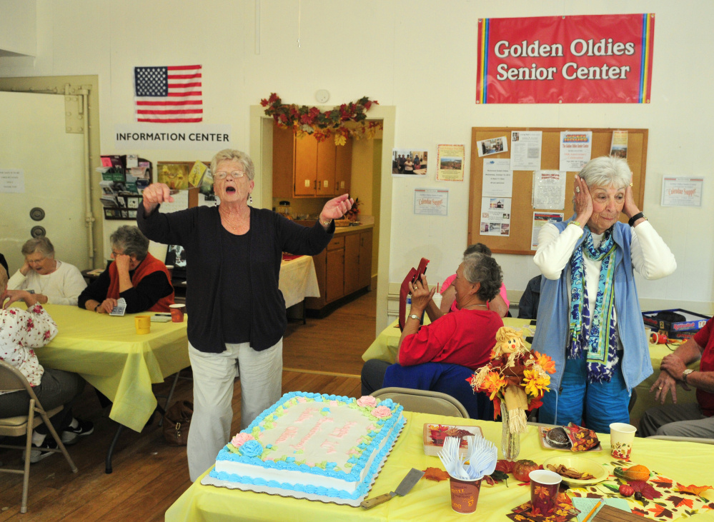 Staff photo by Joe Phelan
Before she cuts the cake, Bette Horning, left, does a Tiny Tim impersonation as Betty Sawyer covers her ears in mock horror Saturday during a 10th-anniversary party for the Golden Oldies Senior Center in Richmond.