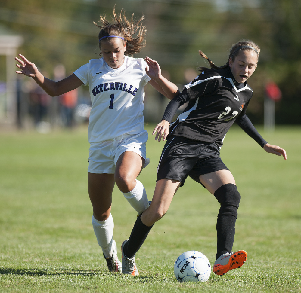 Kevin Bennett photo 
 Waterville's Mackenzie St. Pierre trips while battling for control of the ball with Winslow's Maeghan Bernard on Saturday at Waterville.