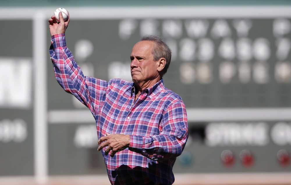Larry Lucchino, who was named President/CEO Emeritus by the Boston Red Sox, throws the ceremonial first pitch before Sunday’s game at Fenway Park.