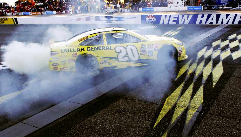 Matt Kenseth celebrates at the finish line after winning the NASCAR Sprint Cup race Sunday at New Hampshire Motor Speedway in Loudon, N.H.