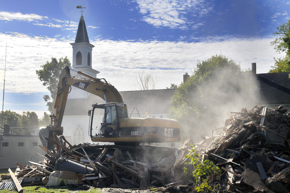 The parsonage at the Dresden Richmond United Methodist Church in downtown Richmond was torn down Monday.