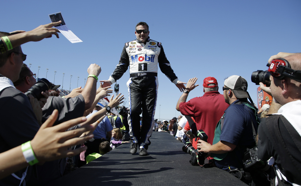 AP photo 
 Tony Stewart greets fans during drivers introduction before the NASCAR Sprint Cup Series race at Chicagoland Speedway on Sept. 20 in Joliet, Ill.