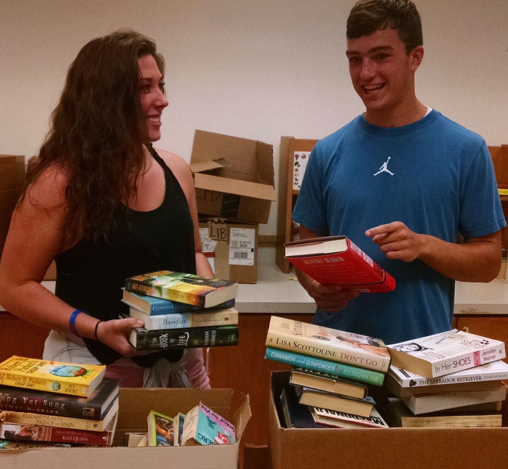 Sydni Collier, left, and Jack Bernatchez are organizing books for the Messalonskee Book Sale set for 9 a.m.-1 p.m. Saturday at Messalonskee High School Library, 131 Messalonskee High Drive, Oakland. For more information, call 465-7381 or email.sjadczak@rsu18.org.