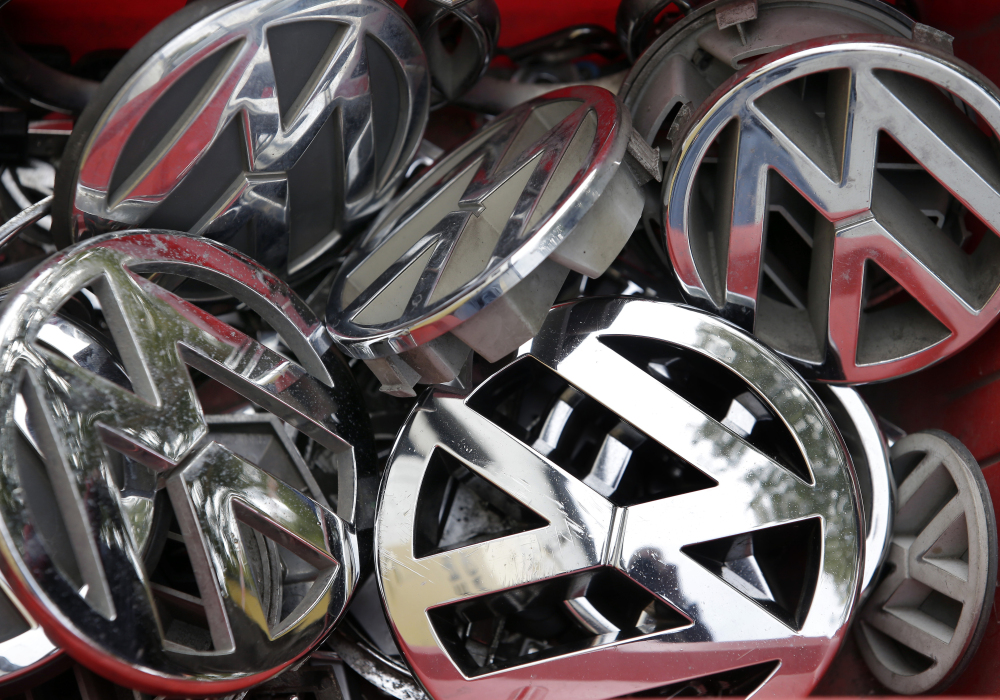 Company logos of the German car manufacturer Volkswagen sit in a box at a scrap yard recently in Berlin, Germany.