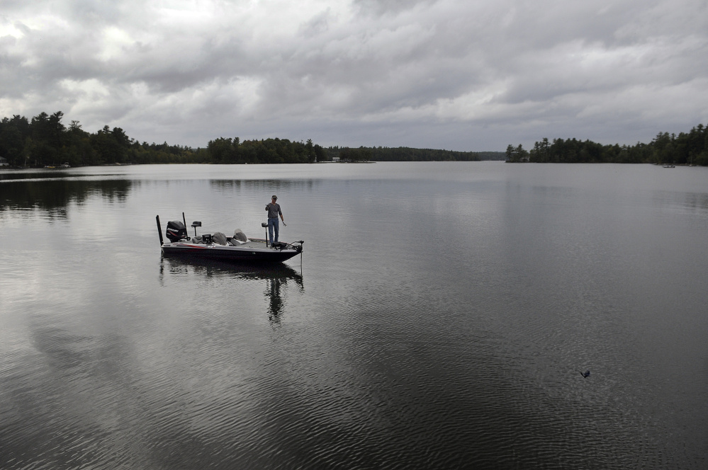 Jim Landry of Wilton tosses a plug while bass fishing Tuesday beneath overcast skies on Lake Cobbessee in Manchester. Several inches of rain is forecast for the remainder of the week, according to the National Weather Service. Despite the threat of getting wet in the days ahead, Landry said, “I might venture out to fish.”