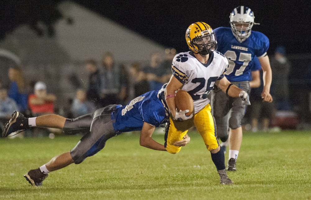 Kevin Bennett photo 
 Mt. Blue running back Christian Whitney heads the up field during a Pine Tree Conference Class B game against Lawrence earlier this season.