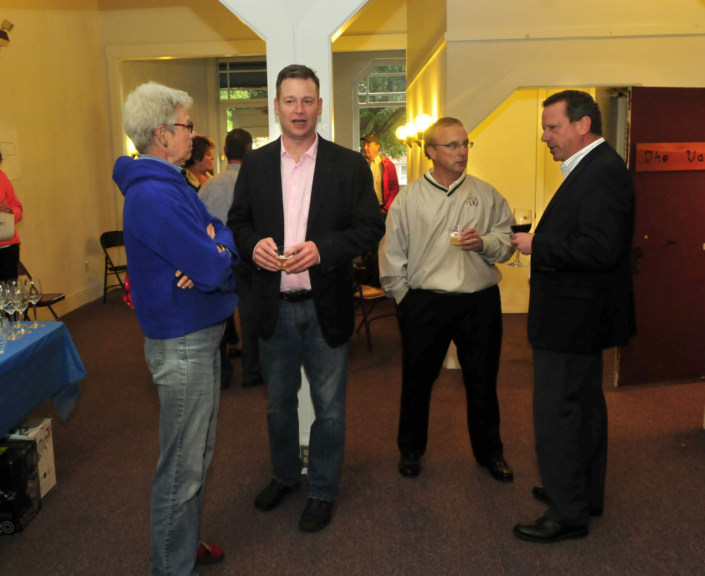 Terroir Oven restaurant owner Jobi Culver, center, speaks with Hillary Schultz as Scott Massey, second from right, speaks with building owner Bill Mitchell during a pre-launch party in Waterville on Wednesday.