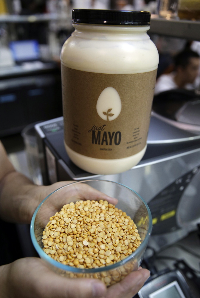 Hampton Creek’s CEO Josh Tetrick holds a bowl of yellow peas used to make Just Mayo, the startup’s eggless, plant-based mayonnaise.