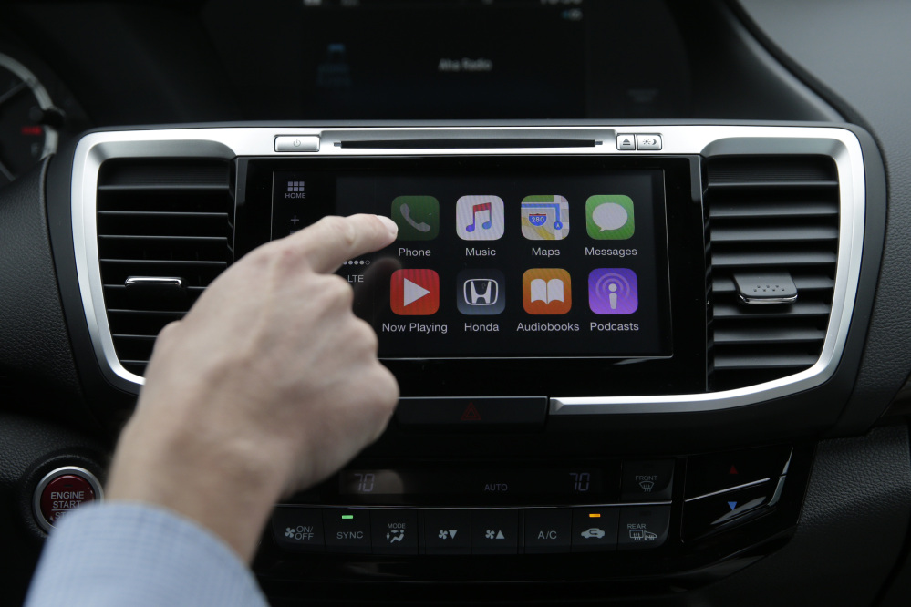 Apple’s CarPlay system, at left, and Google’s Android Auto will be installed in many cars, including some affordable 2016 models.