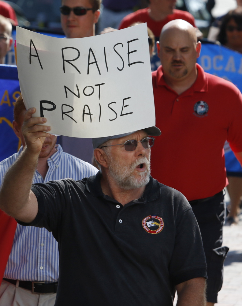 John McGregor, a member of the National Association of Letter Carriers, participates in the Labor Day march Monday in Portland.